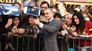 Actor Daniel Radcliffe takes a photo with fans at his star unveiling ceremony on the Hollywood Walk of Fame, November 12, 2015 in Hollywood, California. The British actor, best known for the role of Harry Potter, earned the Walk of Fame's 2,565th star, located in front of the Dolby Theatre on Hollywood Boulevard.  AFP PHOTO/ ROBYN BECK