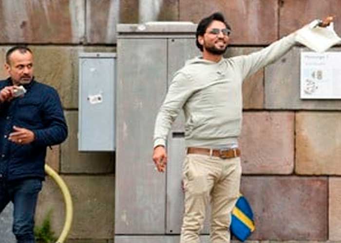 Durante protesta autorizada frente al parlamento sueco dos hombres queman un Corán